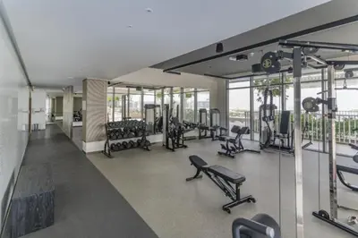 a gym with a lot of treadmills and machines at Vacationer I Luxurious 1 Bedroom Apartment I Private Beach and Infinity Pool Access in Dubai