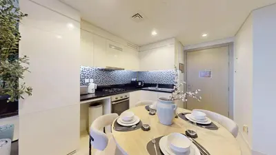 a kitchen with a wooden table and chairs in a kitchen at Vacationer I Luxury 2 Bedroom Apartment I Business Bay, Near Dubai Canal I Aykon City Tower 2 in Dubai