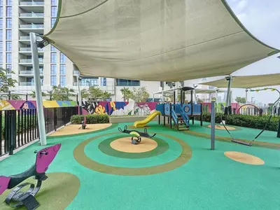 a playground with a slide and swings at Vacationer I Luxury 2 Bedroom Apartment I Business Bay, Near Dubai Canal I Aykon City Tower 2 in Dubai