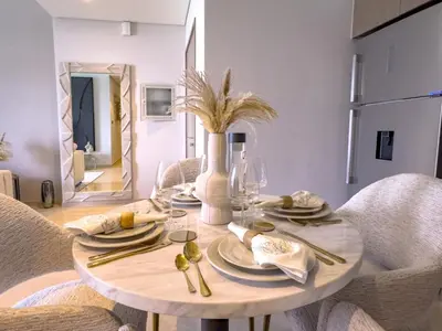 a dining room with a round table with chairs at GRANDE SIGNATURE with a direct Burj Khalifa view and Private Fountain Show with DXB AIRPORT VIP Shuttle option for 6 guests in Dubai