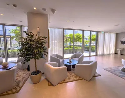 a living room with chairs and a potted plant at GRANDE SIGNATURE with a direct Burj Khalifa view and Private Fountain Show with DXB AIRPORT VIP Shuttle option for 6 guests in Dubai