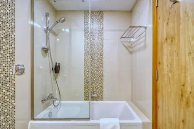 a bathroom with a tub and a shower at Vibrant Waterfront Duplex in Dubai Marina in Dubai