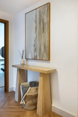 a table in a room with a picture on the wall at Vibrant Waterfront Duplex in Dubai Marina in Dubai