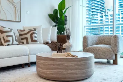 a living room with a couch and a coffee table at Vibrant Waterfront Duplex in Dubai Marina in Dubai