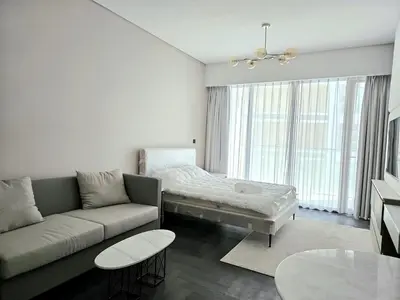 a living room with a couch and a table at Brand New , Skyline View in Dubai