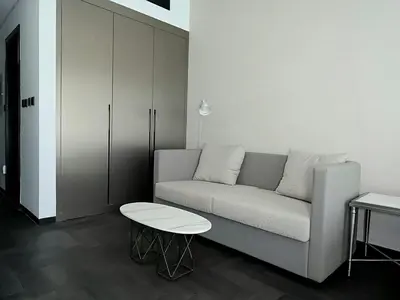 a living room with a couch and a table at Brand New , Skyline View in Dubai