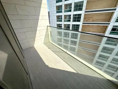 a view of a building from a glass balcony at Brand New , Skyline View in Dubai