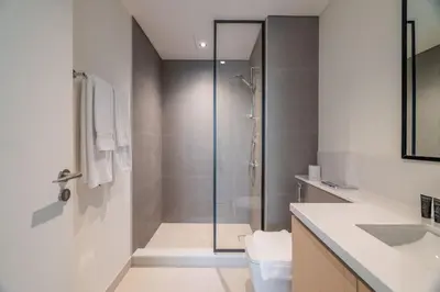 a bathroom with a shower and a sink at Luxurious 4BR with Boulevard View - 10 min to Burj & Mall in Dubai