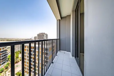 an apartment balcony with a view of the city at Studio in Dubai Production City in Dubai