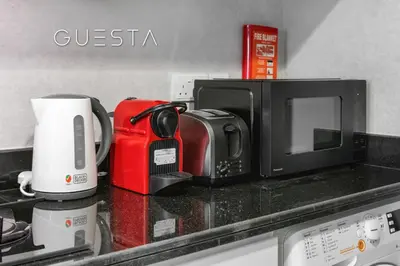a kitchen counter with a microwave and a coffee maker at Damac Hills - Artecia Tower, Dubai in Dubai