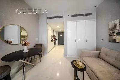 a living room with a couch and a table and a mirror at Damac Hills - Artecia Tower, Dubai in Dubai