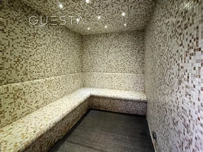 a room with a bench in a brick wall at Damac Hills - Artecia Tower, Dubai in Dubai