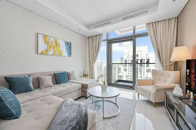 a living room with a couch and a table at Amazing 2 Bed Burj views in Dubai
