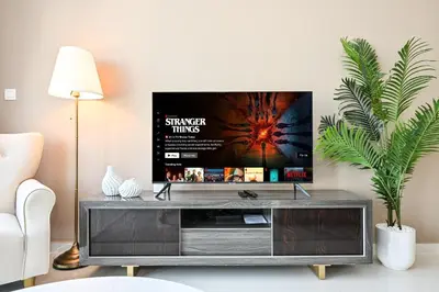 a living room with a television on a entertainment center at Amazing 2 Bed Burj views in Dubai