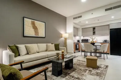 a living room with a couch and a table at Creek palace residence by Hogar in Sabkhah