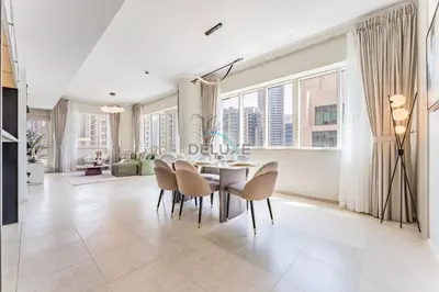 a dining room with a table and chairs at 2BR with Marina View, Walking Distance to Marina Mall, Metro Station & JBR Beach, Al Majara 1, Dubai Marina by Deluxe Holiday Homes in Dubai