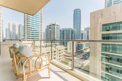 a balcony with a view of a city at 2BR with Marina View, Walking Distance to Marina Mall, Metro Station & JBR Beach, Al Majara 1, Dubai Marina by Deluxe Holiday Homes in Dubai