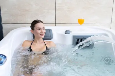 a woman sitting in a bath tub with a drink at Premium Studio Private Jacuzzi Canal View in Dubai