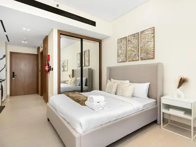 a bedroom with a large white bed in a room at Premium Studio Private Jacuzzi Canal View in Dubai