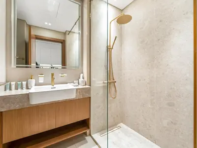 a bathroom with a sink and a shower at Premium Studio Private Jacuzzi Canal View in Dubai