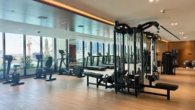 a gym with cardio equipment in a building at Premium Studio Private Jacuzzi Canal View in Dubai