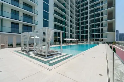 an image of a swimming pool in a building at Ahlan HH - Brand New Summer Suite, Near Circle Mall in Dubai