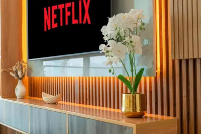 a vase with white flowers sitting on a shelf at Ahlan HH - Brand New Summer Suite, Near Circle Mall in Dubai