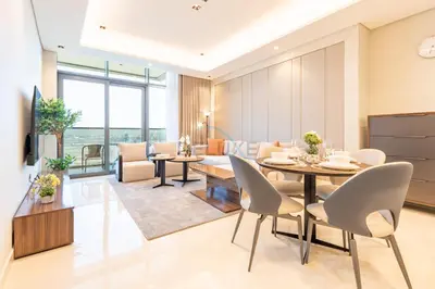 a dining room and living room with a table and chairs at Skyline View 1BR, Minutes Away from Downtown and Dubai Mall, Nobles Tower, Business Bay by Deluxe Holiday Homes in Dubai