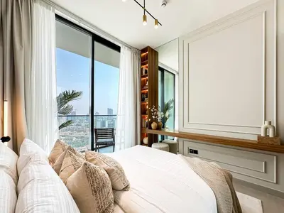 a bedroom with a bed and a large window at Feel at Home Stylish 1BR in Binghatti Tulip Dubai in Dubai