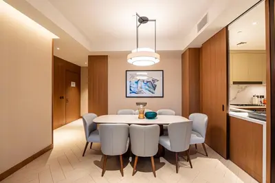 a kitchen and a dining room with a table and chairs at Venetian - Signature 3BR with Burj Khalifa & Fountain views in Dubai