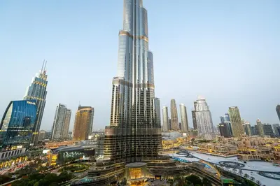 a view of a city with a tall skyscraper at Venetian - Signature 3BR with Burj Khalifa & Fountain views in Dubai