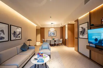 a living room with a couch and a tv at Venetian - Signature 3BR with Burj Khalifa & Fountain views in Dubai