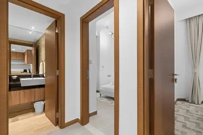 a bathroom with a door leading to a bedroom at Modern apartment in a prime location in Dubai! in Dubai