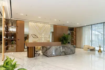 a lobby with a reception desk in a building at Modern 1br In Jvc Balcony Pool Free Parking in Dubai
