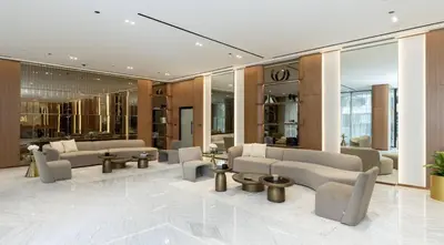 a lobby with couches and tables in a building at Modern 1br In Jvc Balcony Pool Free Parking in Dubai