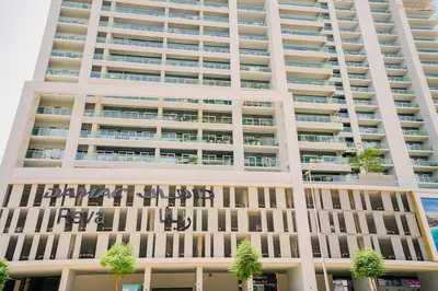 a large white building with writing on it at Bnbeyond's Serene Poolside Bliss in Dubai