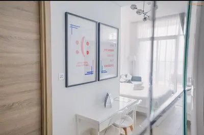 a white bathroom with a sink and a mirror at Bnbeyond's Modern Marina Pad in Dubai