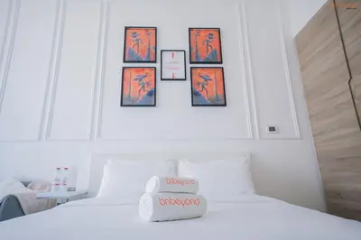 a bedroom with two beds with pictures on the wall at Bnbeyond's Modern Marina Pad in Dubai