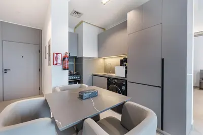 a dining room with a table and chairs at ALiving Modern & Chic 1BR I MAG960 in Dubai