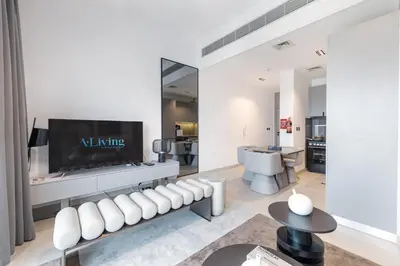 a living room with a tv on a wall at ALiving Modern & Chic 1BR I MAG960 in Dubai