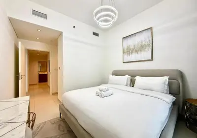 a bedroom with a bed with a stuffed animal on it at Luxurious and Spacious 2BR Burj Crown Downtown in Dubai