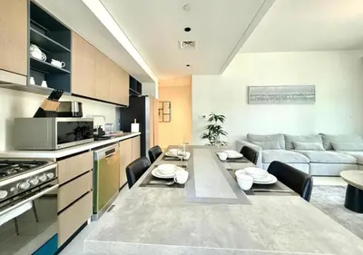 a kitchen and living room with a table and a couch at Luxurious and Spacious 2BR Burj Crown Downtown in Dubai