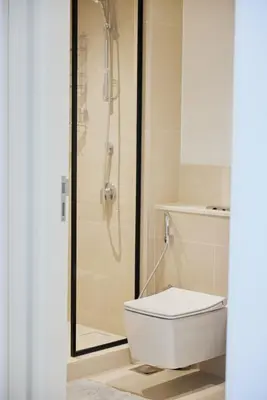 a white toilet in a bathroom with a shower at Spacious 1BR Burj Crown Downtown in Dubai