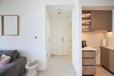 a living room with a couch and a kitchen at Spacious 1BR Burj Crown Downtown in Dubai