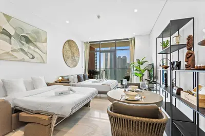 a living room with a bed and a couch at Designer Studio w Burj Khalifa view in Peninsula in Dubai