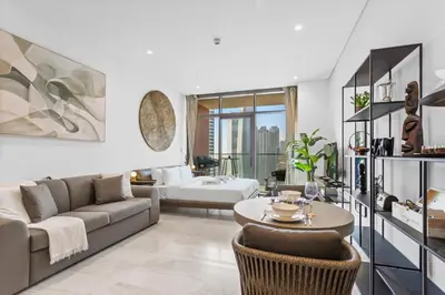 a living room with a couch and a table at Designer Studio w Burj Khalifa view in Peninsula in Dubai