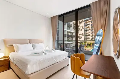 a bedroom with a bed and a large window at Chic Retreat 1Bedroom with Pool view in Dubai