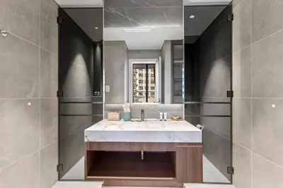 a bathroom with a large sink and a mirror at Chic Retreat 1Bedroom with Pool view in Dubai