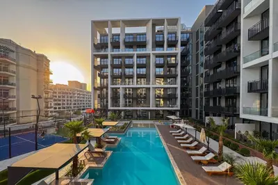 an apartment complex with a swimming pool and buildings at Chic Retreat 1Bedroom with Pool view in Dubai