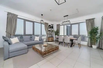 a living room with a couch and a table at Downtown Luxury 1 Bed with City Skyline Views in Dubai